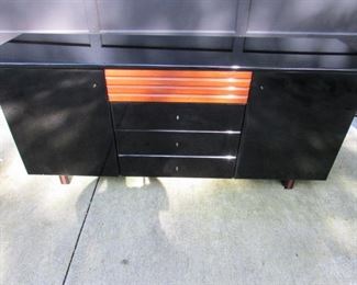 Contemporary black laminate credenza (Made in Italy). 66.5" long x 28.75" tall x 18.5" deep. Scattered areas of light scuffing to surface as expected with age and use. PRICE: $150.00