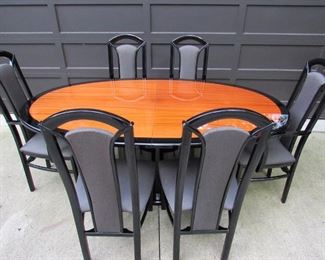 Contemporary oval dining table (or conference room table), Made in Italy. (4) side chairs, (2) arm chairs, (1) leaf that is 19.75" wide), and custom pads are included. Without leaf, table is 72.5" long x 42.5" wide x 30" tall. Chairs are approximately 19" wide x 17.5" deep x 43" tall. Light scuffing to table as expected with age and use and chair upholstery does have some picking to fabric as seen in additional detail pictures. PRICE FOR SET: $495.00