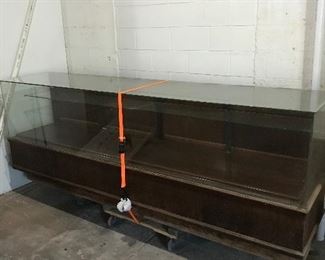 Glass and wooden display case is very good condition.  9’ long x 24” deep x 40” high
