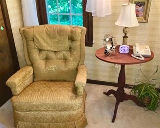 vintage upholstered chair, wooden side table, lamps, picture frames, etc