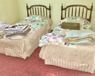twin beds, numerous hand made quilts