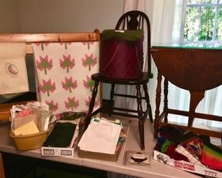 Quilt rack, misc. chairs, sewing chests, side table w/ double drop down sides, boxes of misc. fabric