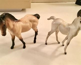Porcelain horses, each with a broken leg, repaired 