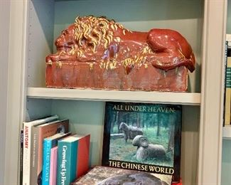 $750 PAIR. 20th Century glazed ceramic lion resting on pedestal; Two of two. 12"H x 6.75"D 21.5"W