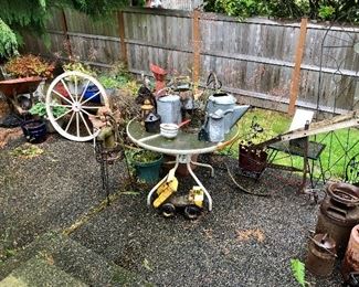 Outdoor decor, watering cans, tonka truck, patio table, wheelbarrow
