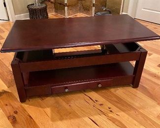 Coffee table with top that raises