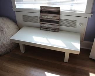 Low white table with sliding tops