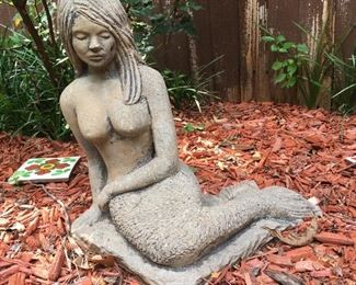 A fairly liberal looking concrete mermaid.