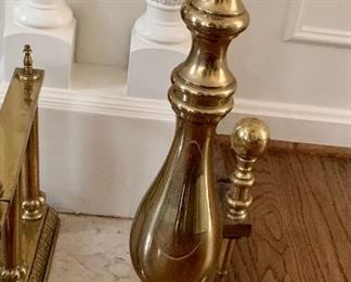 Pair of brass fireplace andirons; each is 11" W x 27" H x 24.5" D. Two of two. 