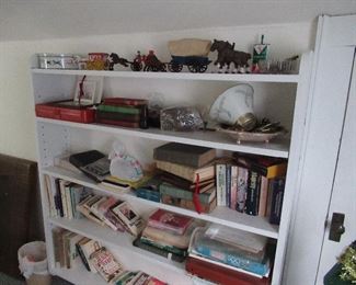 Cast iron figures on top shelf.  Books 