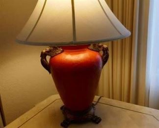 $65 - Table lamp.  Faux leather finish in a rich cinnabar red color.  Bird accents at the top. 27" high (after)