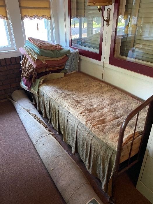 Antique bed, blankets, area rug