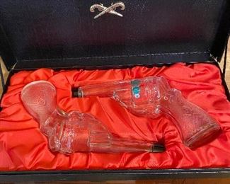 Unique gun-shaped decanters in case
