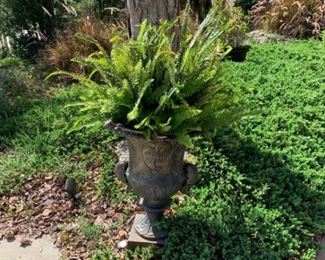 Variety of plants and large garden pots. 
