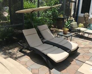 Keeping cool! Enjoy southern comfort on this double chaise lounge with umbrella.  