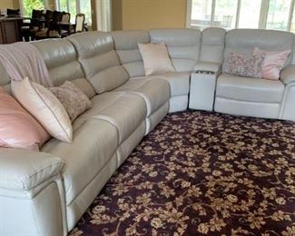 “Your surroundings should always make you smile, especially relaxing on this 5-piece leather sectional with 2 recliners, Color: "Oyster" , Convenient USB/remote compartment and 2 cup holders. Sections can be repositioned to accommodate your room or design preferences.  Long side is 9', short side is 7', 35" wide x 40" tall.                                                         
9' x 12' rug is also available. 