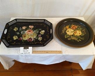 Beautifully decorated serving trays with elaborate floral paintings.