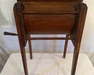 Antique hand crank washing machine with wooden handles in the side