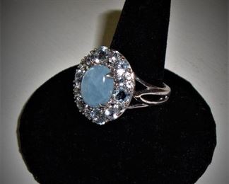 GORGEOUS MILKY AQUA CABACHON SURROUNDED BY AQUAMARINE GEMSTONES, SET IN STERLING SILVER. 1.40ct TW