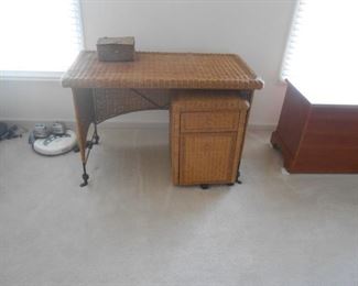 Wicker over a metal frame desk with file cabinet