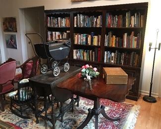 Folding game table, drop leaf table, book cases. Books are a variety of everything. 