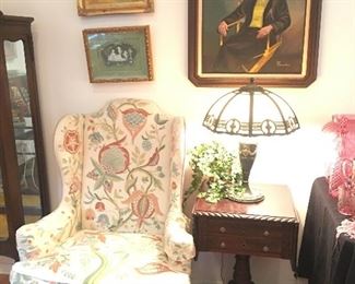 Beautifully upholstered Wing back chair, pedestal side table with sides that raise. More art by my client, framed wedgewood piece. 