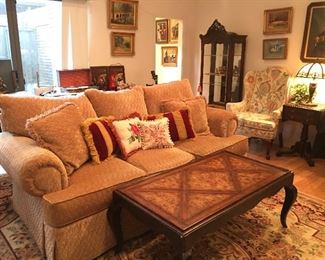 Beautiful comfy beige couch, antique style coffee table.