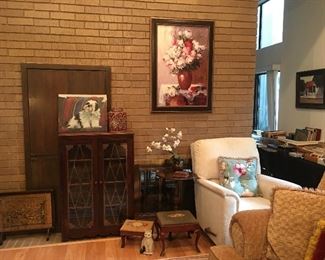 Fireplace screen, display case, recliner, foot stools. 
 Shih Tzu  Art by my client & floral print.
