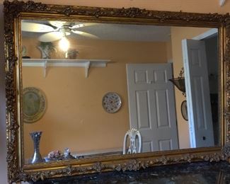 very large gold-framed ornate mirror