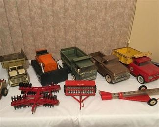 Vintage Ny-Lint, Structo, Tonka Toy, and Tru Scale trucks and implements