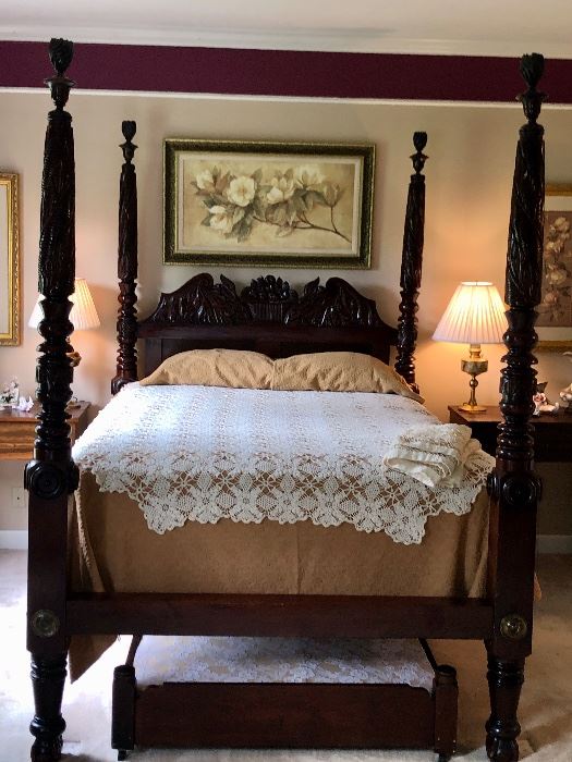 1840’s highly carved antique mahogany Queen size bed With twin trundle bed.  Breaks down into a bundle for moving or shipping.  The family has been told this is one of two know beds in this style.  The other is in the James Buchanan’s home museum.  The hand crochet coverlet is actually a canopy.  There is also a crocheted dust ruffle. 