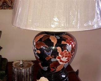 Close up of lamp and capodimonte rose, blue lid jar made in Bavaria, silver cigar box has been remived