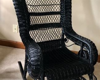 Antique black wicker rocker