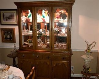 Photo of lighted oak china cabinet