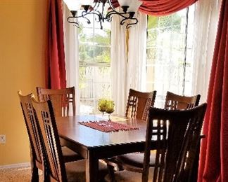 Mid-century modern dining table and chairs with extra leaf to expand table.