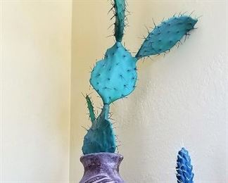 Decorative faux cactus and Inca southwest style pottery.