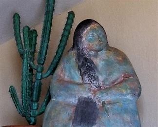 Very large turquoise and bronze colored Native American woman sculpture. Beautiful piece! Decorative faux cactus and southwest style pottery.