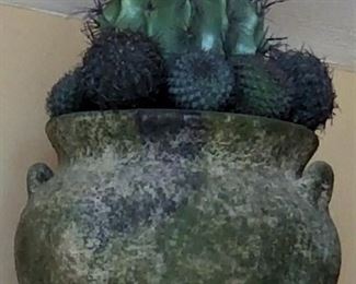 Decorative faux cactus and an unusual green southwest style pottery.
