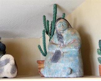 Very large turquoise and bronze colored Native American woman sculpture. Beautiful piece! Decorative faux cactus and southwest style pottery.