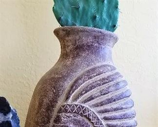 Decorative faux cactus and Inca southwest style pottery.