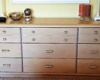 Whitewashed wood dresser which is a part of the bedroom set.