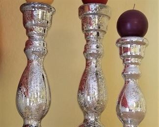 A trio of silver candle holders