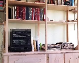 Handcrafted light colored wood bookshelves and storage.