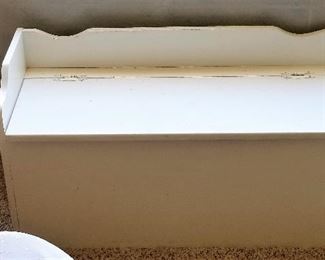 Child's white toy storage trunk.