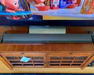 Sony 55” 2160p Smart 4K Ultra HD TV with a Sony 2.1 Channel Soundbar with Wi-Fi & Bluetooth.  Hooker Furniture cherry wood entertainment console