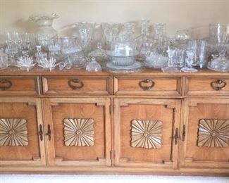 Buffet with large selection of glassware.