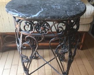 Wrought iron table with granite top.