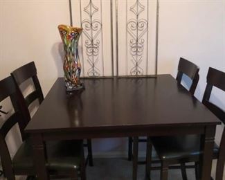 Counter height table with 4 stools; wall panels; art vase