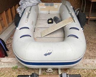Inflatable low hull Mercury boat with pull trailer