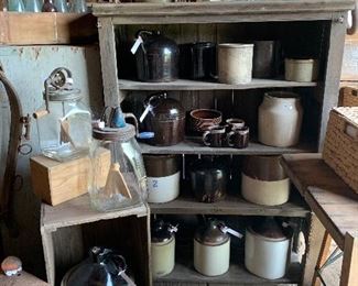 Antique crocks, primitive jugs, vintage butter churns, primitive cupboard, old barn pulley, antique bottles